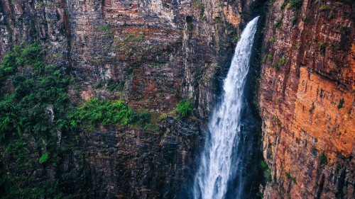 Image waterfalls in brown rocky mountain during daytime