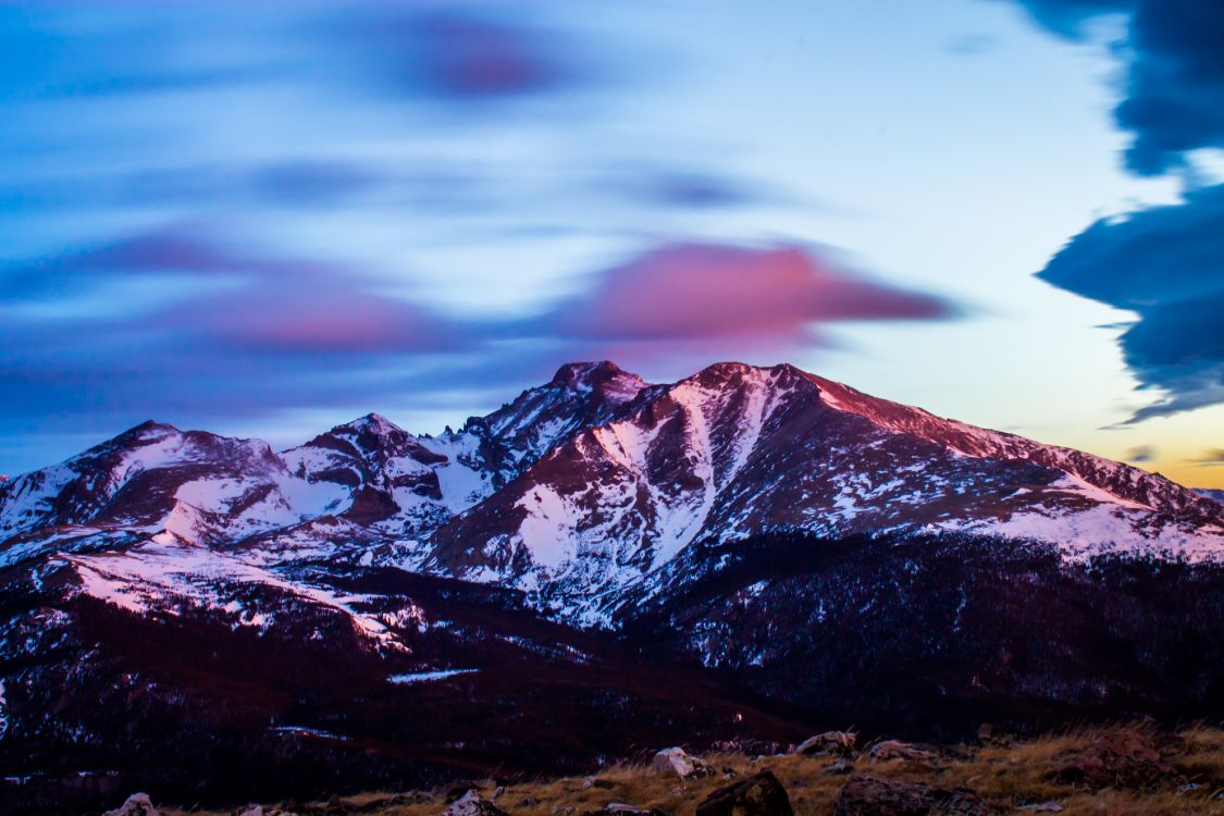 brown and white mountains under cloudy sky during daytime