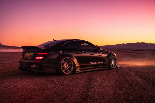 Image black porsche 911 on brown sand during daytime