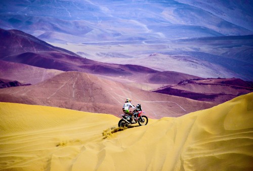 Image man riding motocross dirt bike on desert during daytime