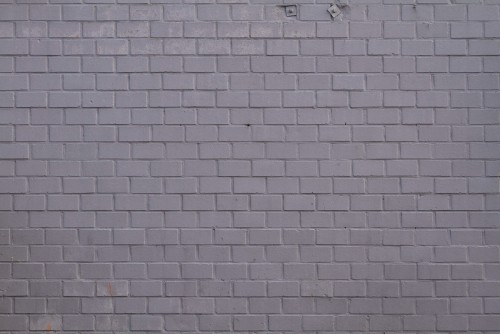 Image grey brick wall with white light bulb