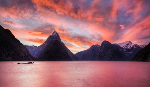 Image body of water near mountain during sunset