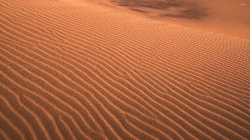 Image brown sand with blue water