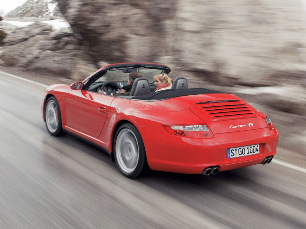 red ferrari convertible on road during daytime