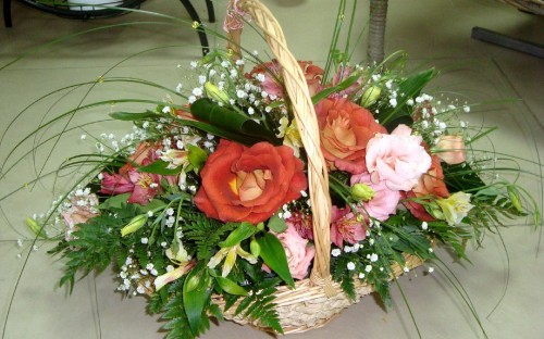 Image pink and white roses in brown woven basket