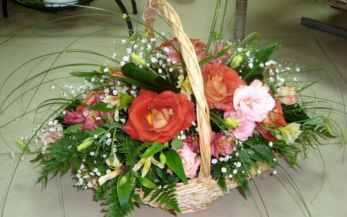 pink and white roses in brown woven basket