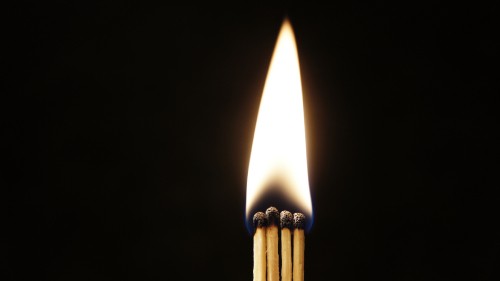 Image lighted candle in black background