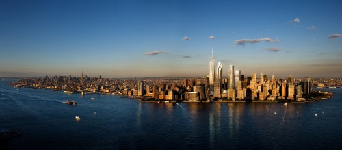 Image city skyline across body of water during daytime