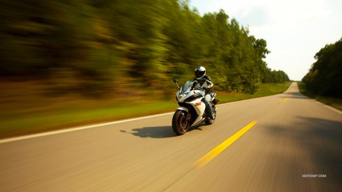 Image man riding motorcycle on road during daytime