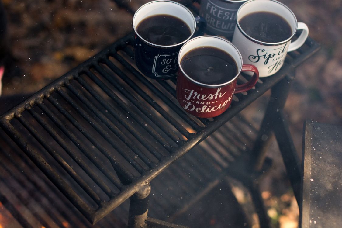 red and white coffee cup on black metal frame