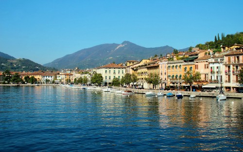 Image white and brown concrete building near body of water during daytime