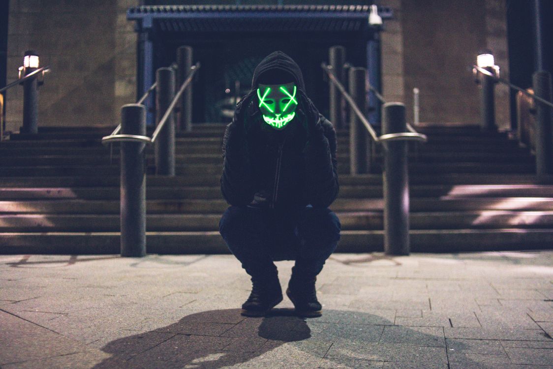 Person in Black Hoodie Wearing Green Mask. Wallpaper in 4882x3255 Resolution