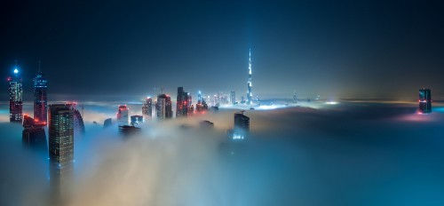 Image city skyline with lights turned on during night time