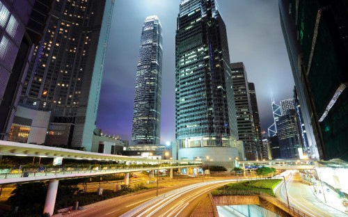 Image cars on road near high rise buildings during night time