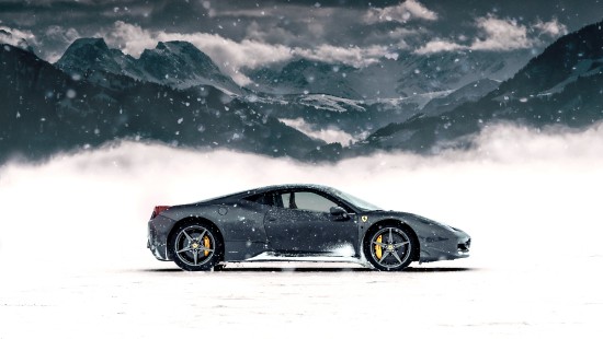 Image black coupe on snow covered ground