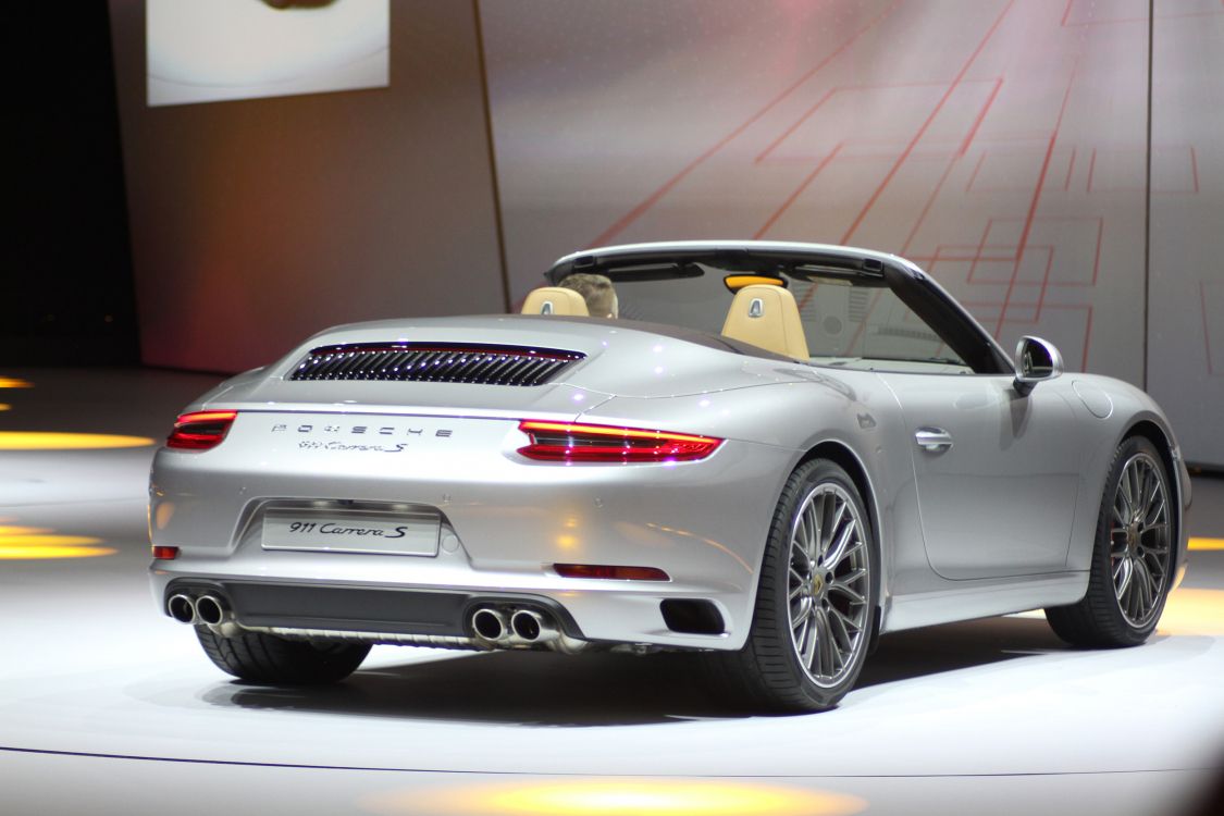 white porsche 911 parked in a room