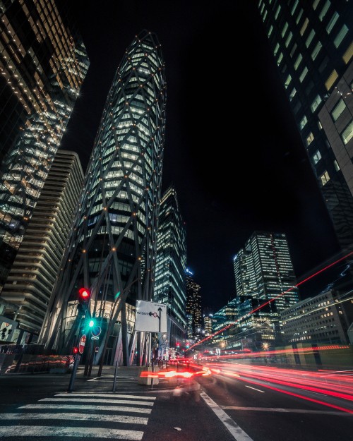 Image cars on road near high rise building during night time