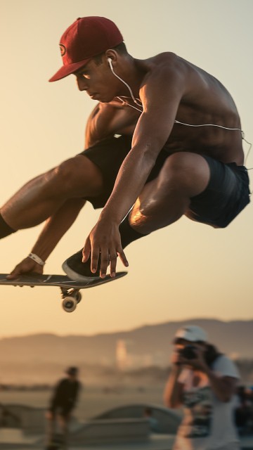 Image man in red cap and blue shorts doing stunts