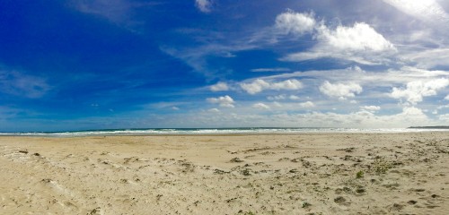 Image white sand beach under blue sky and white clouds during daytime