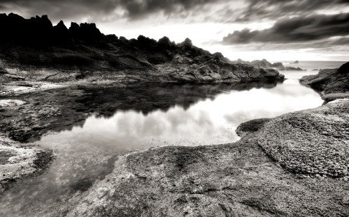 Image grayscale photo of lake near mountain