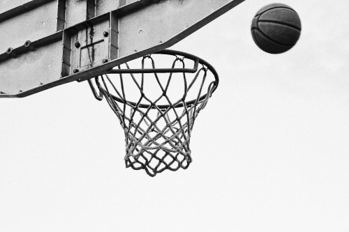 Image basketball on basketball hoop in grayscale photography