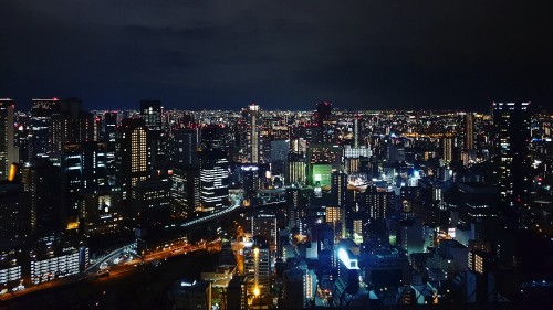 Image city with high rise buildings during night time