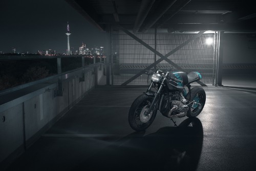 Image black and silver motorcycle parked on gray concrete floor