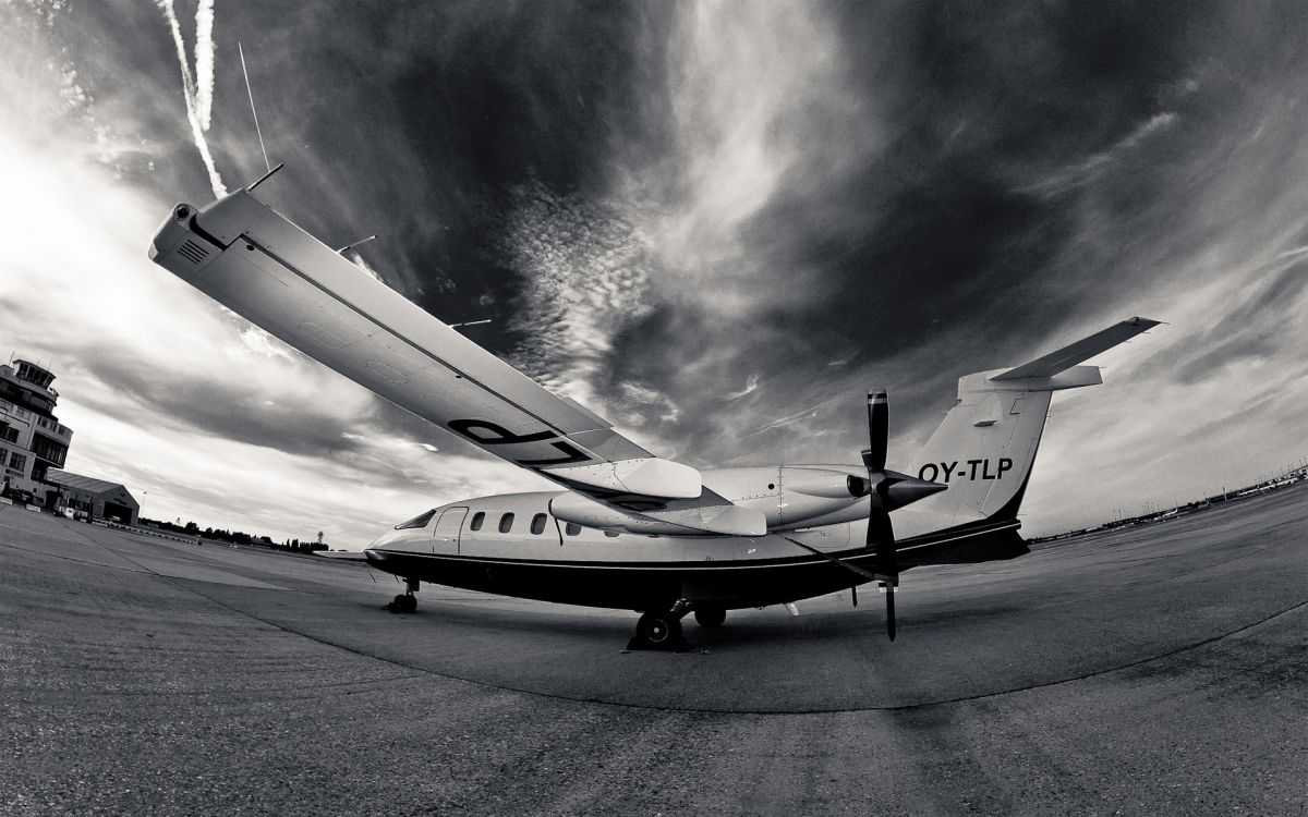 Airplane with yellow and white wings flying above the clouds 6K wallpaper  download