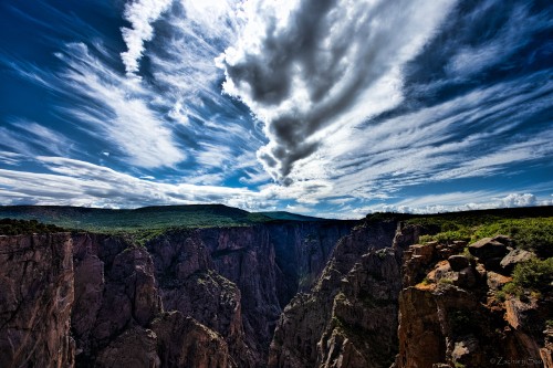 Image green and brown mountain under white clouds and blue sky during daytime