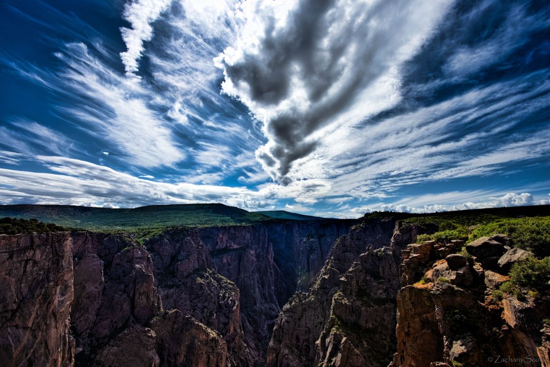 green and brown mountain under white clouds and blue sky during daytime