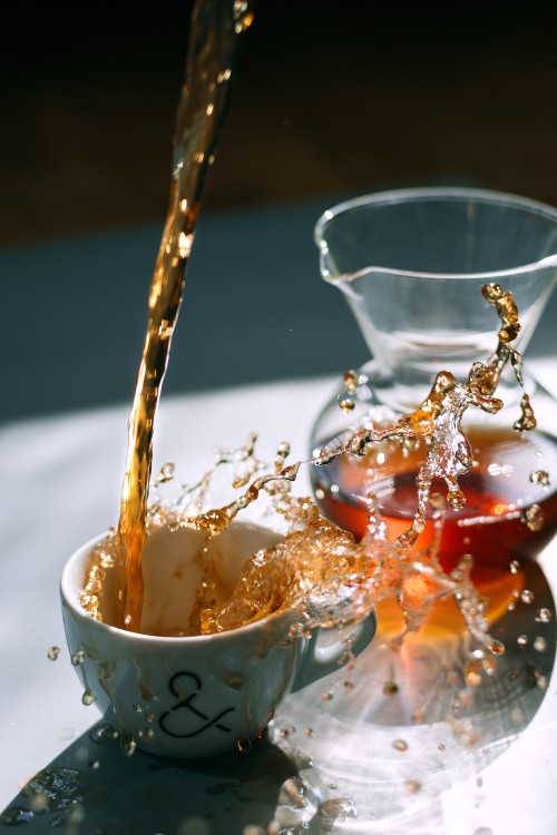 Image water pouring on white ceramic cup