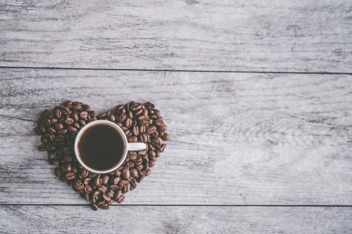 Image white ceramic mug on brown coffee beans