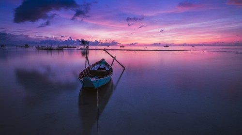 Image white and blue boat on calm water under blue sky during daytime