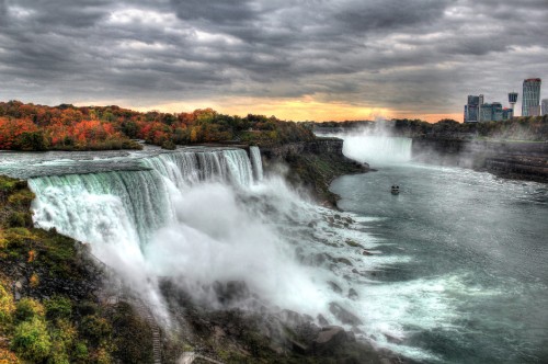 Image waterfalls under gray cloudy sky during daytime