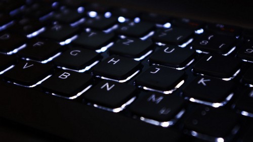 Image black computer keyboard on black surface