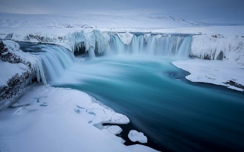 Image water falls on rocky shore during daytime