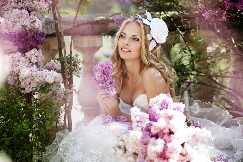 Image woman in white wedding dress holding bouquet of flowers