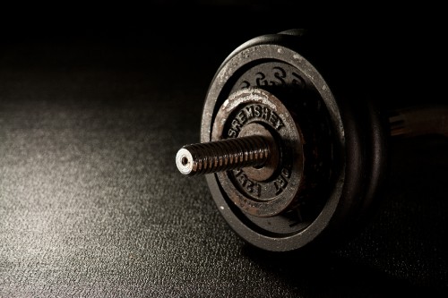 Image silver and black dumbbell on black textile