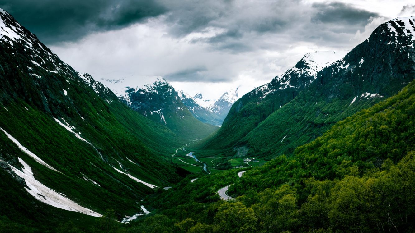 green mountains under gray clouds