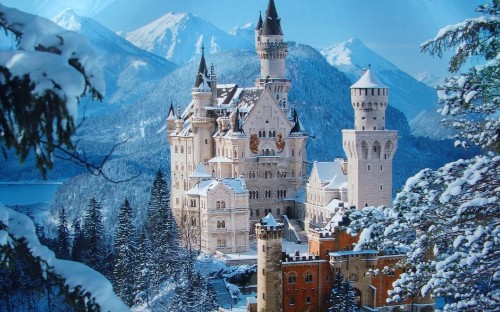 Image white and brown castle on snow covered mountain during daytime