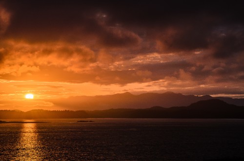 Image body of water under cloudy sky during sunset