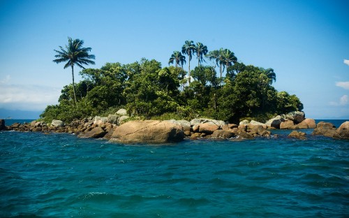 Image brown rocks on body of water during daytime