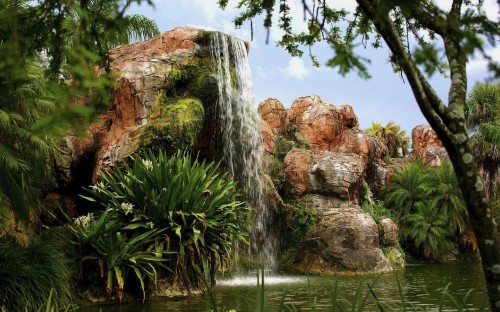 Image brown rock formation near water falls during daytime