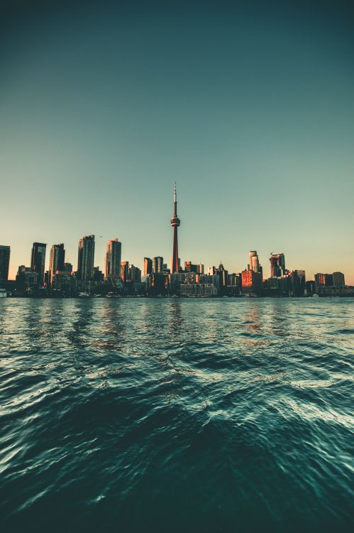 City Skyline Across Body of Water During Daytime. Wallpaper in 4207x6311 Resolution