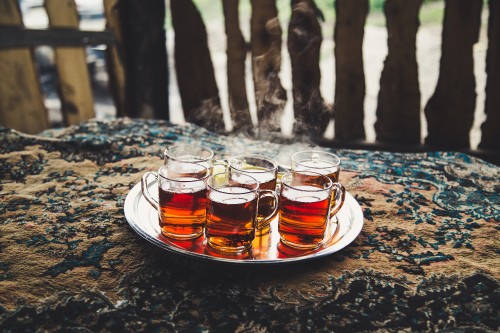 Image clear drinking glasses on white ceramic plate