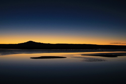 Image silhouette of mountain near body of water during daytime