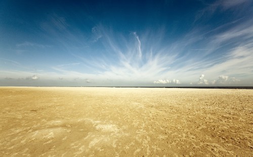 Image brown sand under blue sky during daytime