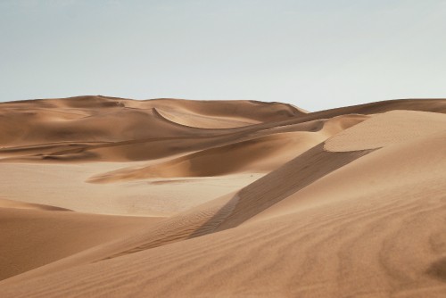 Image brown sand under blue sky during daytime