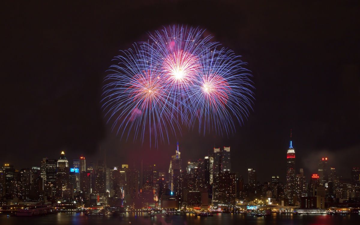 fireworks display over city buildings during night time