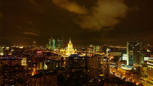 Image city with high rise buildings during night time